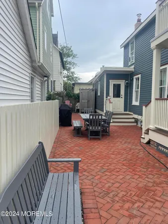 a view of a patio with a table and chairs