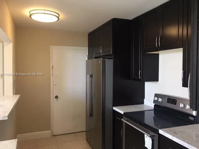 a kitchen with a refrigerator and a sink