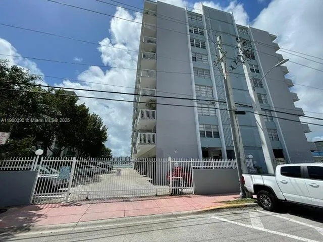 a view of a swimming pool with lawn chairs and a big yard