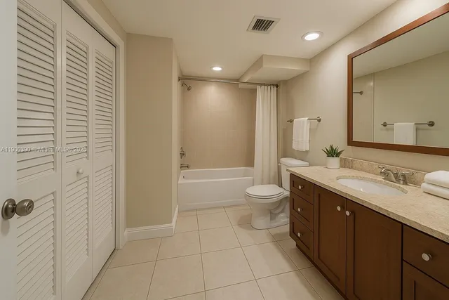 a spacious bathroom with a granite countertop sink a toilet and shower