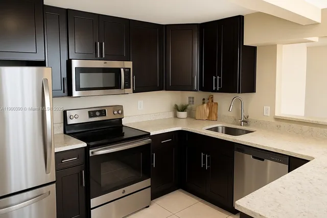a kitchen with a sink stove and microwave