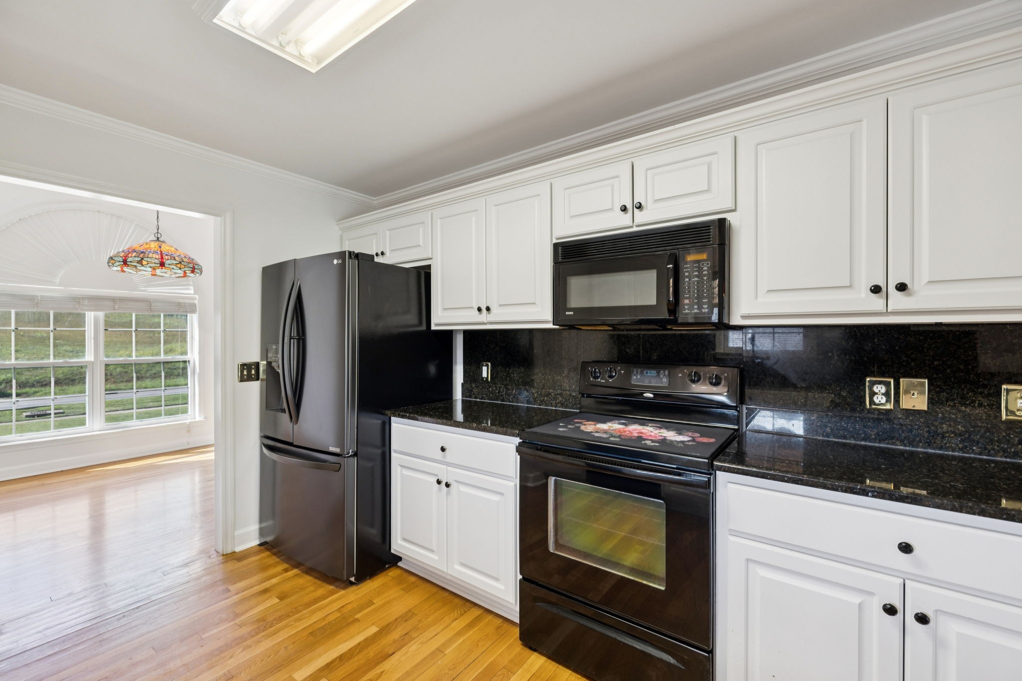 3679 Old State Highway 11 Springfield, TN 37172 - Photo 12 of 50 a kitchen with granite countertop a refrigerator stove and microwave