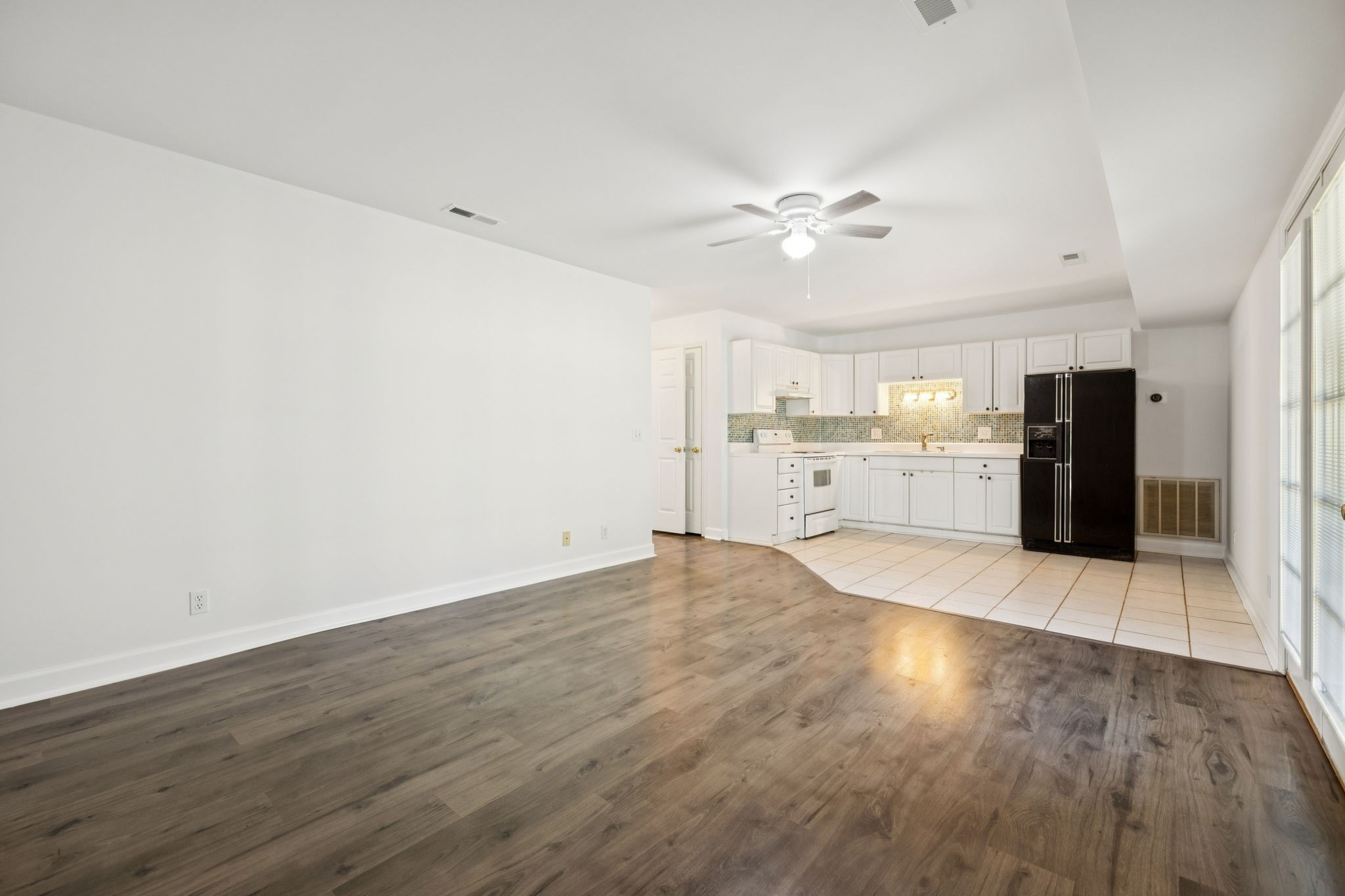 3679 Old State Highway 11 Springfield, TN 37172 - Photo 28 of 50 a view of an empty room with a kitchen counter space and wooden floor