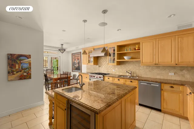 a kitchen with stainless steel appliances granite countertop a stove a sink and cabinets