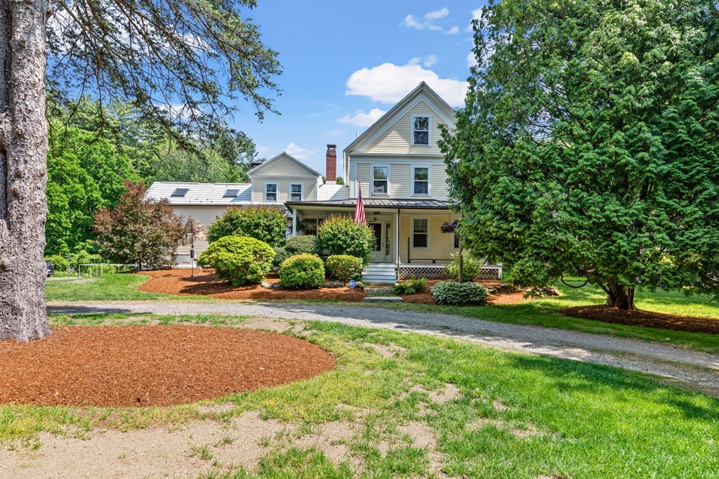 264 Gleasondale Road Stow, MA 01775 - Photo 1 of 1 a front view of a house with a yard and garage