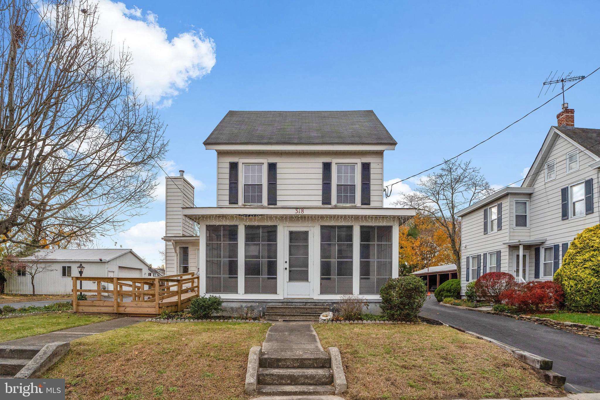 a front view of a residential apartment building with a yard