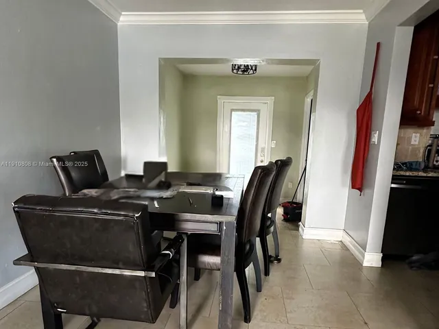 a view of a dining room with furniture and a flat screen tv