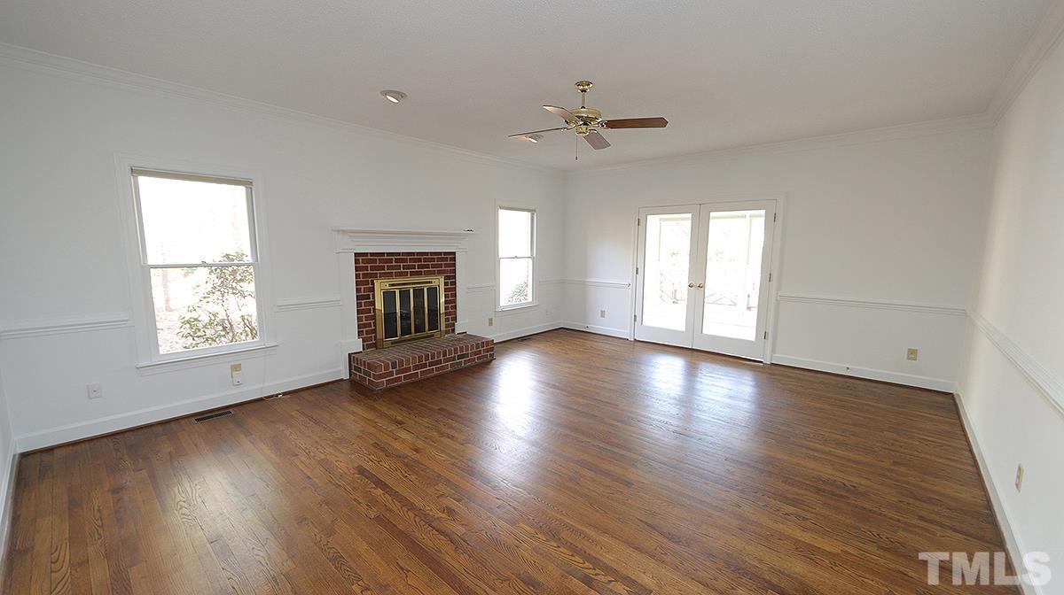 7949 Footman Way Raleigh, NC 27615 - Photo 11 of 28 a view of an empty room with wooden floor and a window