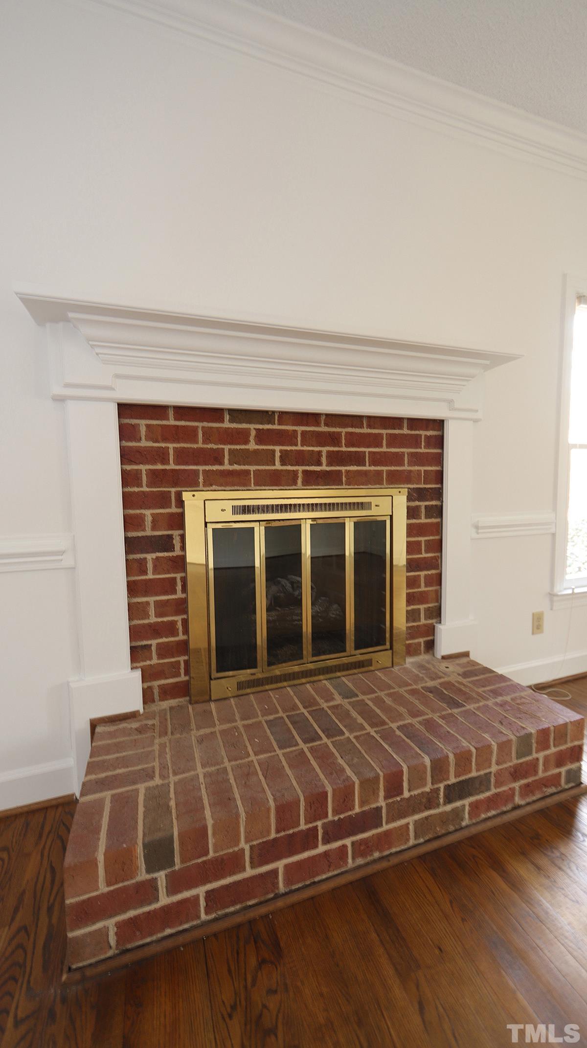 7949 Footman Way Raleigh, NC 27615 - Photo 12 of 28 a view of a fireplace with wooden floor