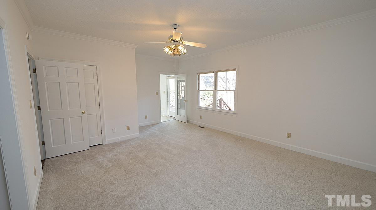 7949 Footman Way Raleigh, NC 27615 - Photo 16 of 28 an empty room with chandelier and windows