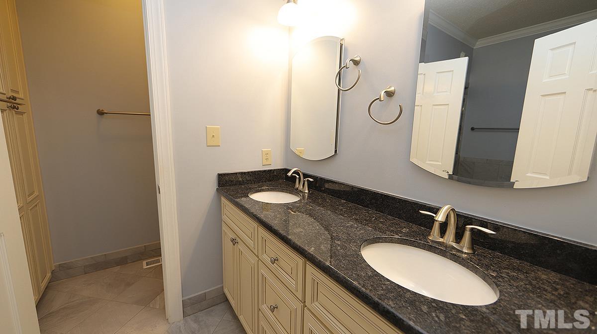 7949 Footman Way Raleigh, NC 27615 - Photo 17 of 28 a bathroom with a granite countertop double vanity sink and a mirror