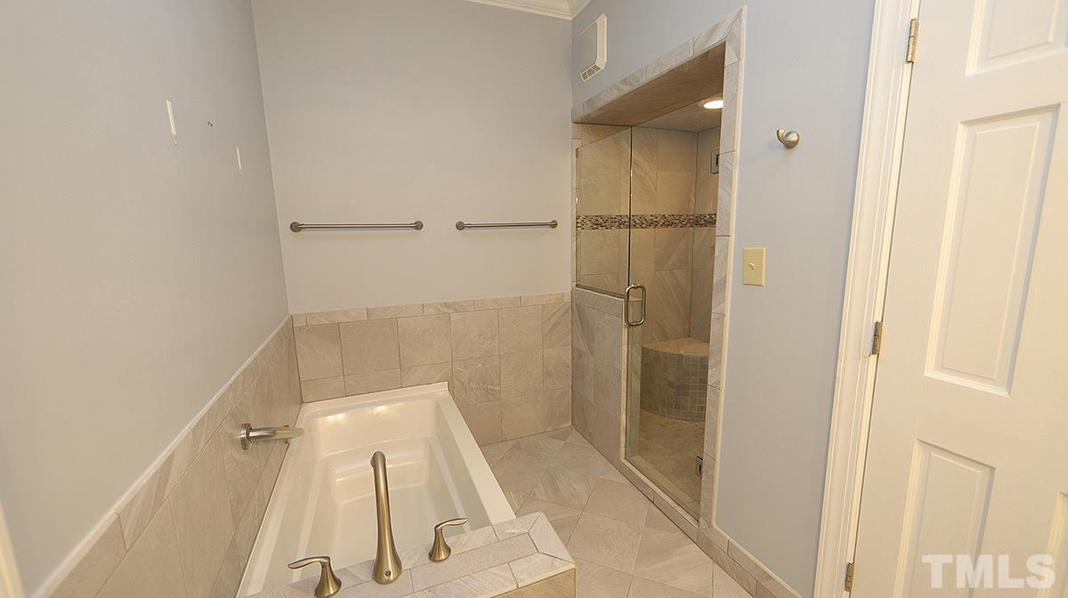 7949 Footman Way Raleigh, NC 27615 - Photo 18 of 28 a bathroom with a shower