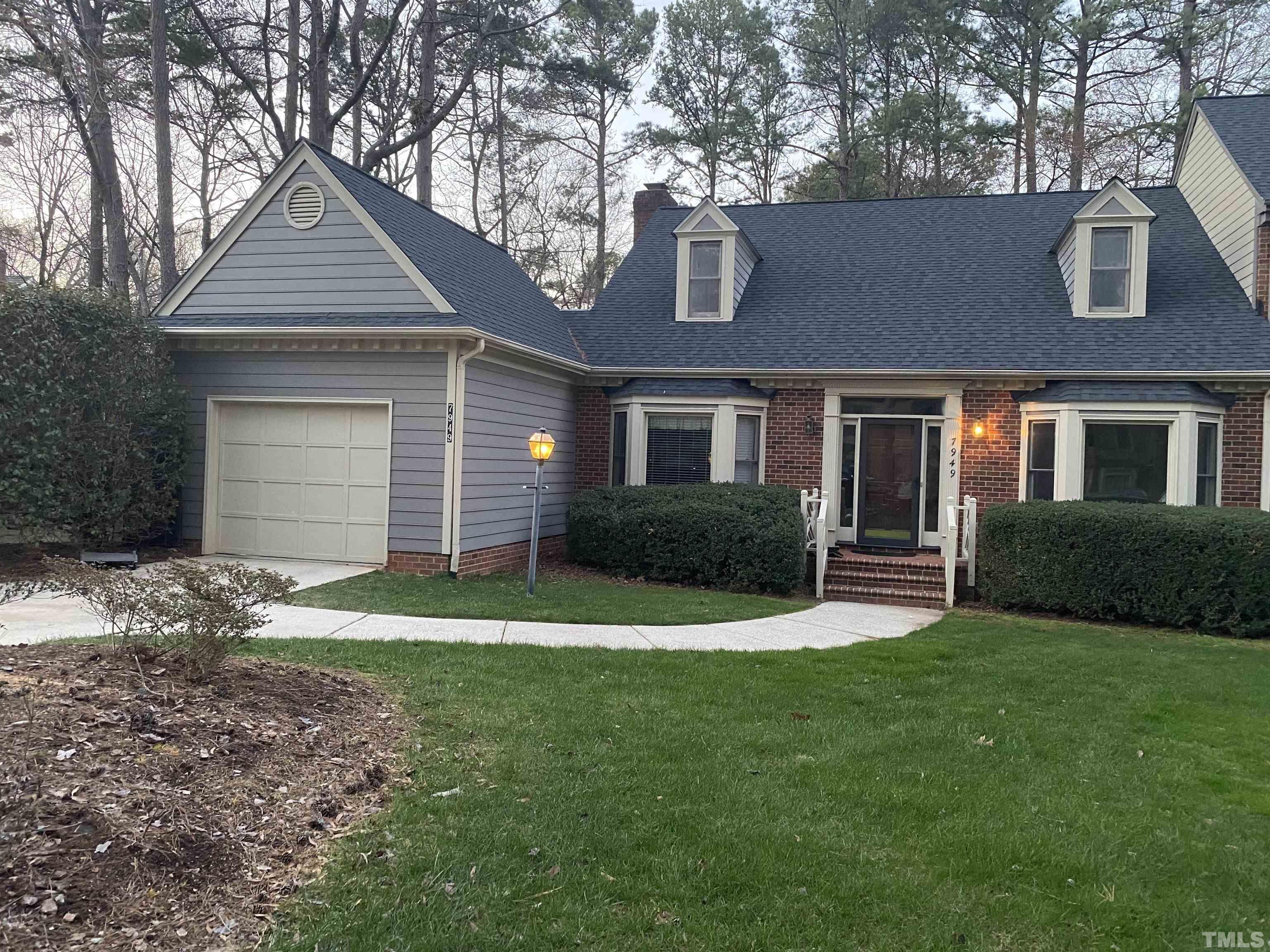 7949 Footman Way Raleigh, NC 27615 - Photo 2 of 28 a front view of a house with a yard and garage