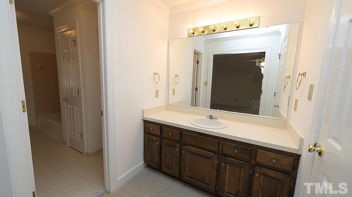 7949 Footman Way Raleigh, NC 27615 - Photo 21 of 28 a bathroom with a sink and a mirror