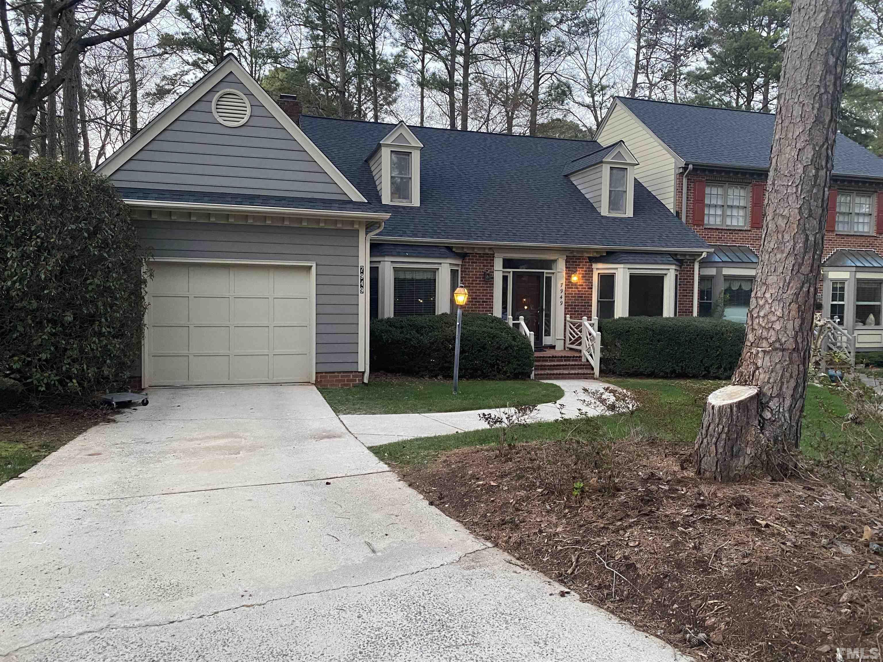 7949 Footman Way Raleigh, NC 27615 - Photo 4 of 28 a front view of a house with a yard and garage