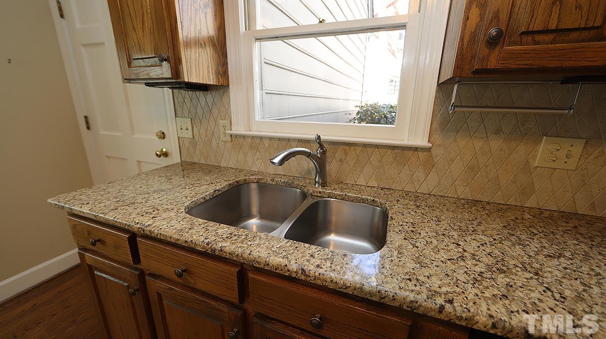 7949 Footman Way Raleigh, NC 27615 - Photo 9 of 28 a kitchen with a sink and a window