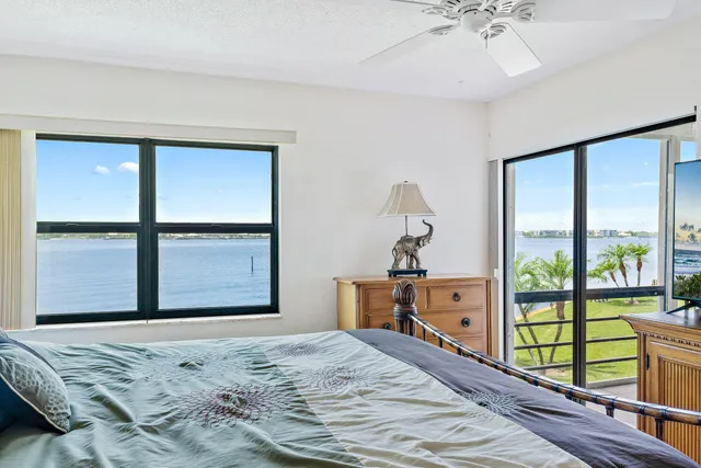 a bedroom with a bed and large window