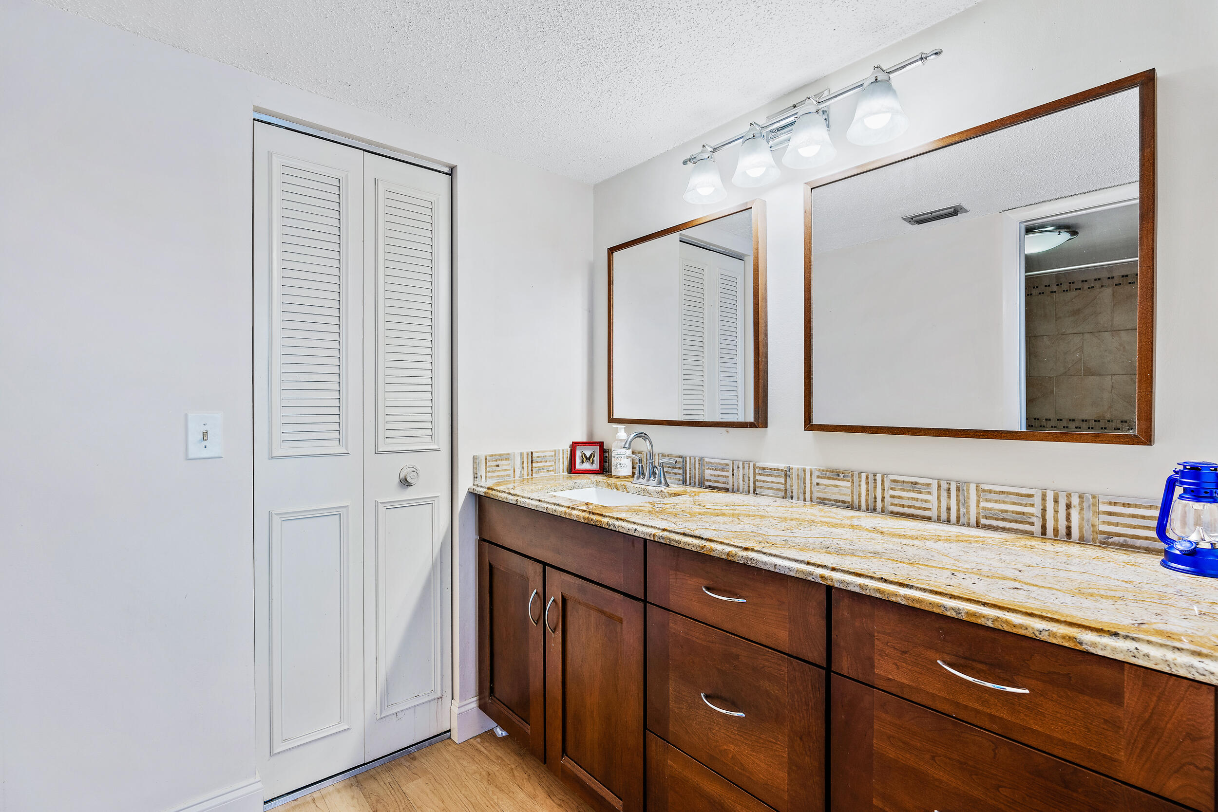 1950 Southwest Palm City Road, Unit 1202 Stuart, FL 34994 - Photo 12 of 21 a bathroom with a double vanity sink and a mirror