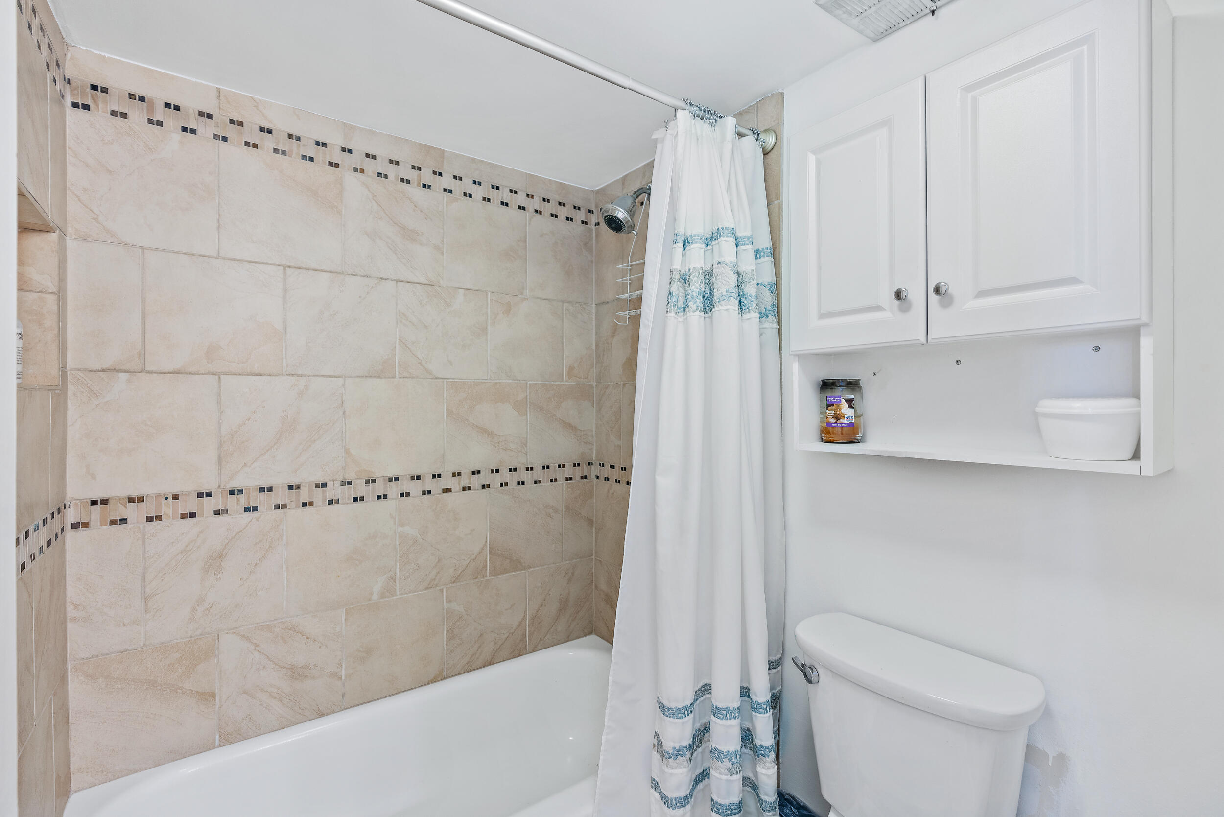 1950 Southwest Palm City Road, Unit 1202 Stuart, FL 34994 - Photo 13 of 21 a bathroom with a shower a toilet and a sink