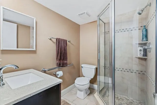 a bathroom with a toilet sink and shower