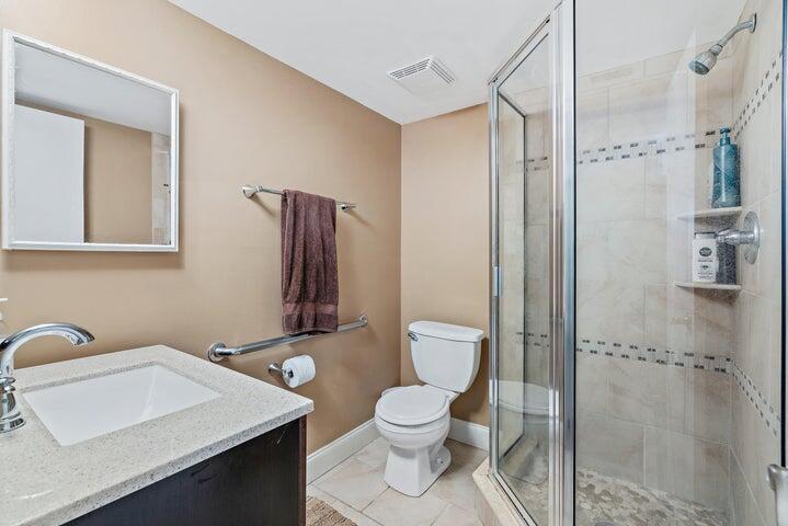 1950 Southwest Palm City Road, Unit 1202 Stuart, FL 34994 - Photo 15 of 21 a bathroom with a toilet sink and shower