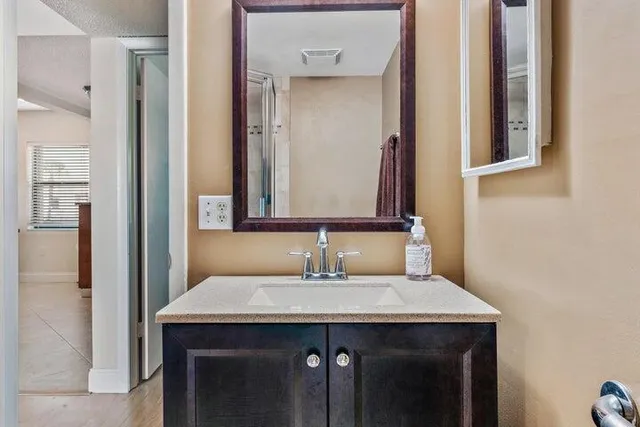 a bathroom with a sink and a mirror