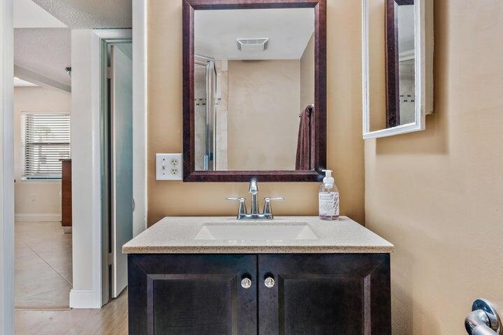 1950 Southwest Palm City Road, Unit 1202 Stuart, FL 34994 - Photo 16 of 21 a bathroom with a sink and a mirror