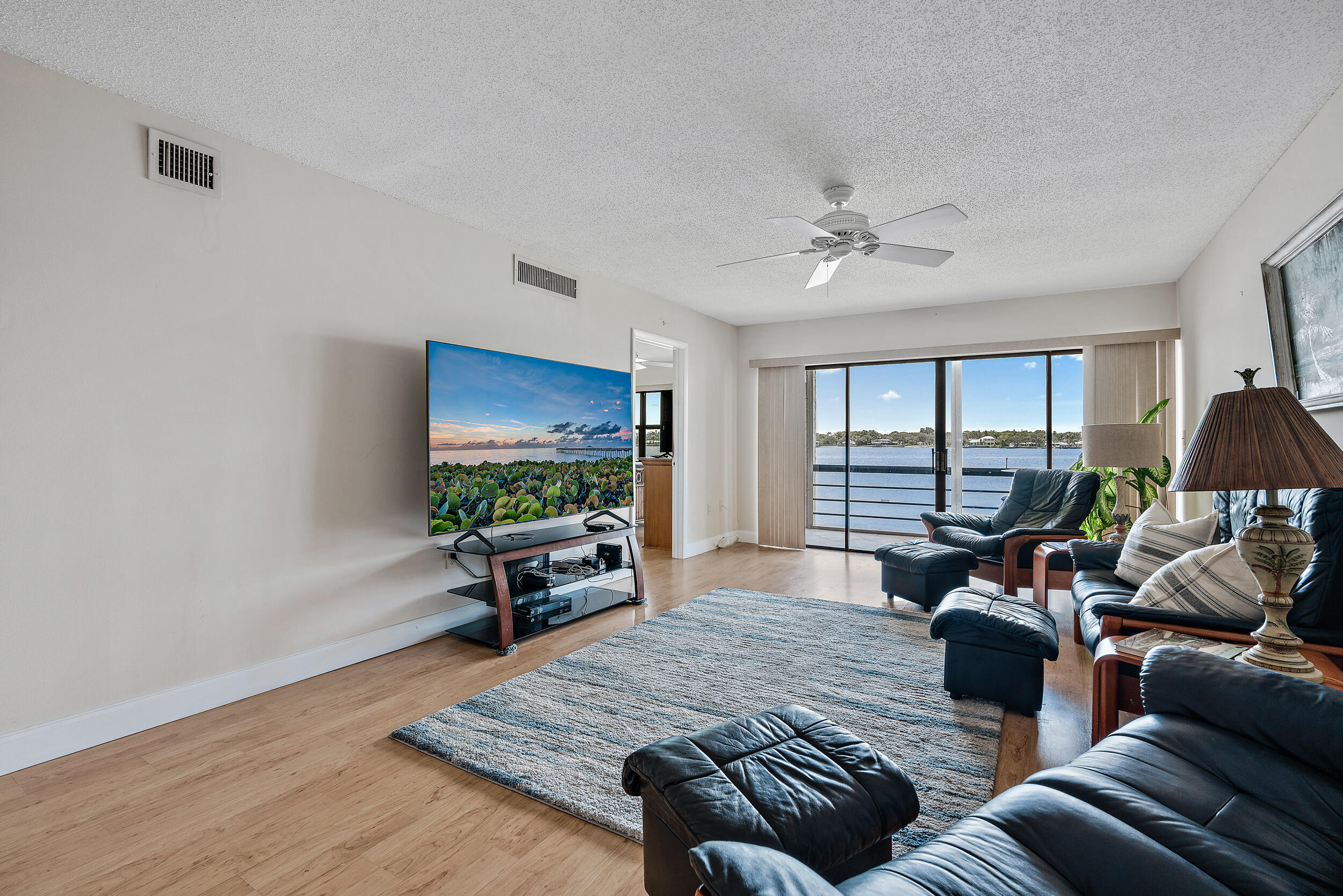 1950 Southwest Palm City Road, Unit 1202 Stuart, FL 34994 - Photo 6 of 21 a living room with furniture and a flat screen tv