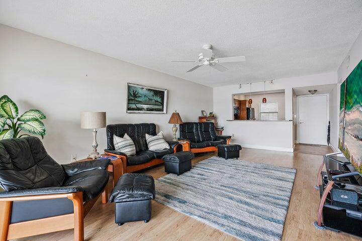 1950 Southwest Palm City Road, Unit 1202 Stuart, FL 34994 - Photo 7 of 21 a living room with furniture and a wooden floor