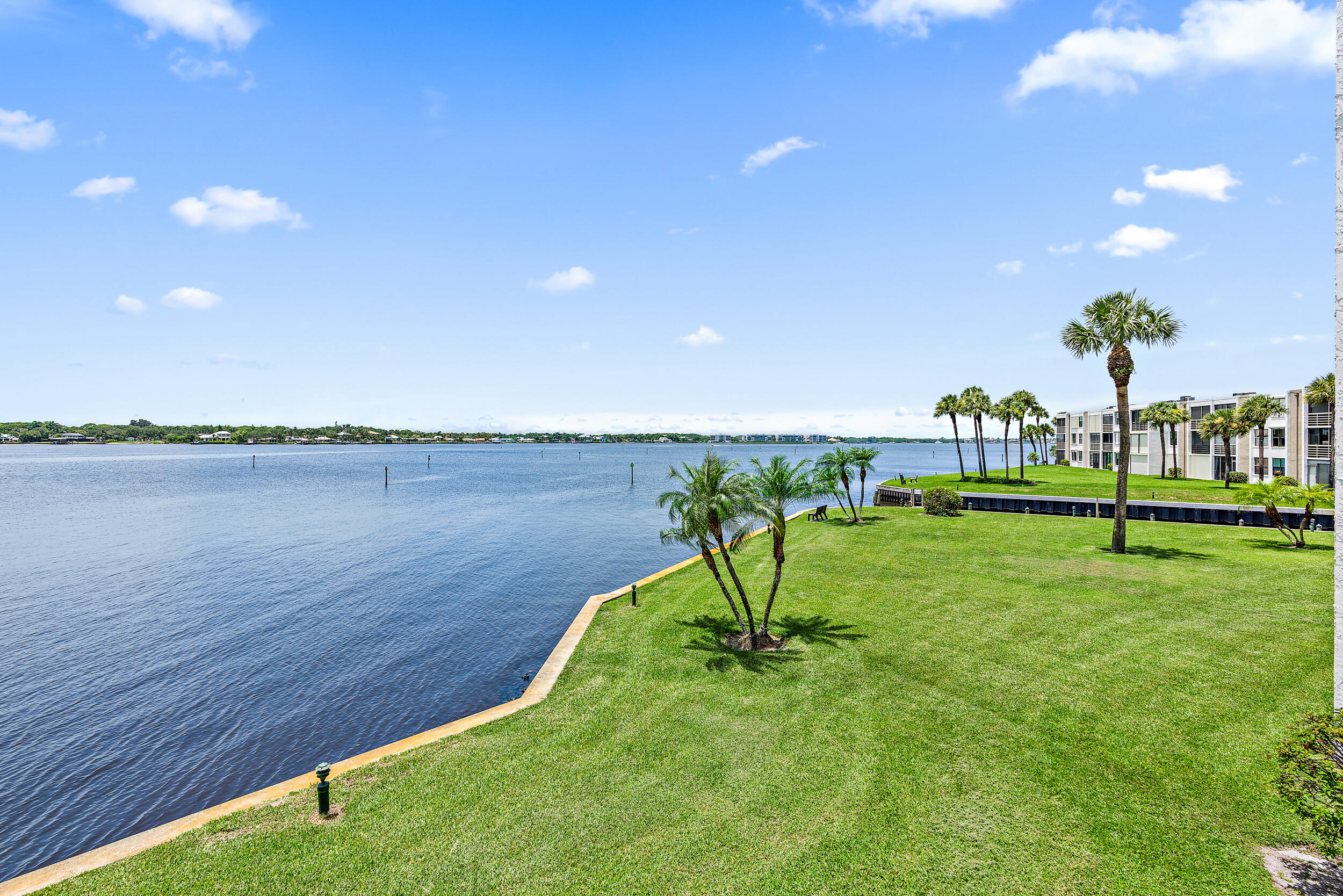 1950 Southwest Palm City Road, Unit 1202 Stuart, FL 34994 - Photo 9 of 21 a view of a lake with a yard