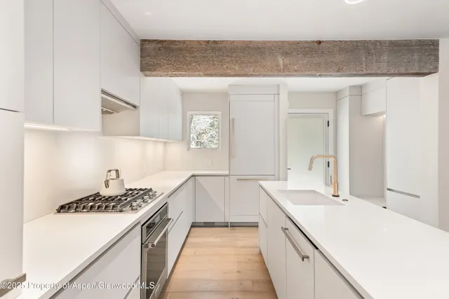 a kitchen with a sink and stove