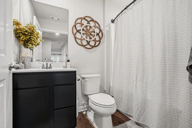 a bathroom with a sink a toilet and a mirror