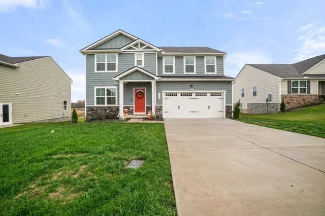 a front view of a house with a yard and garage