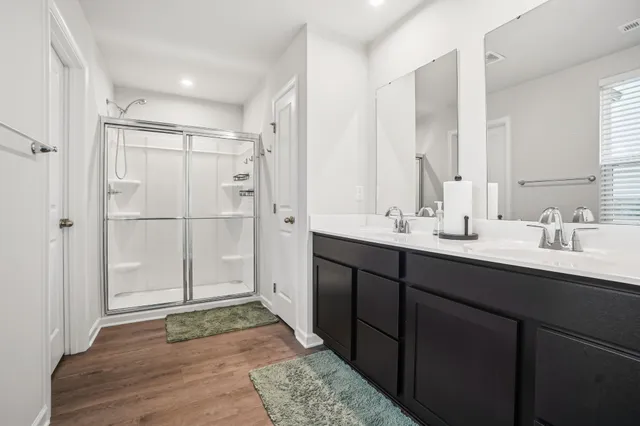 a bathroom with a shower and a sink
