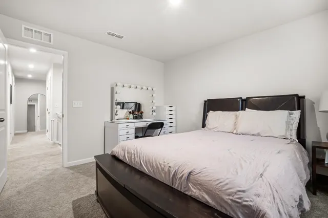 a bedroom with bed and window