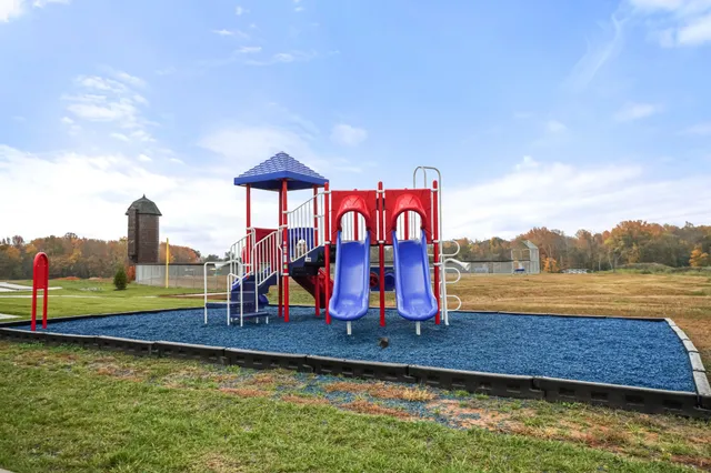 a view of a lake with a big yard and large trees