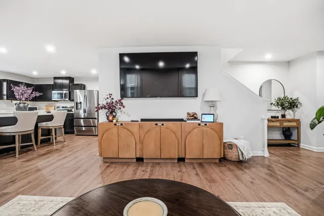 a living room with furniture and kitchen view