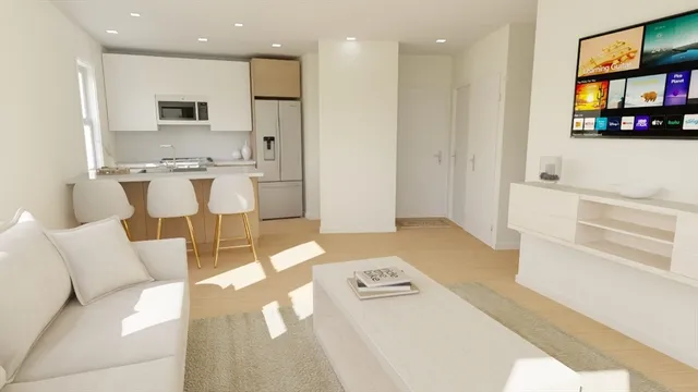 a living room with furniture and a kitchen view