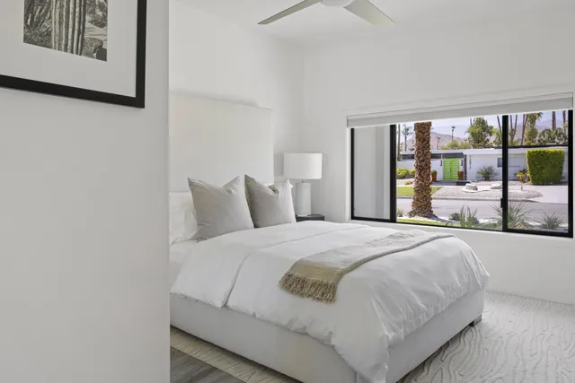 a bedroom with a large bed and a large window