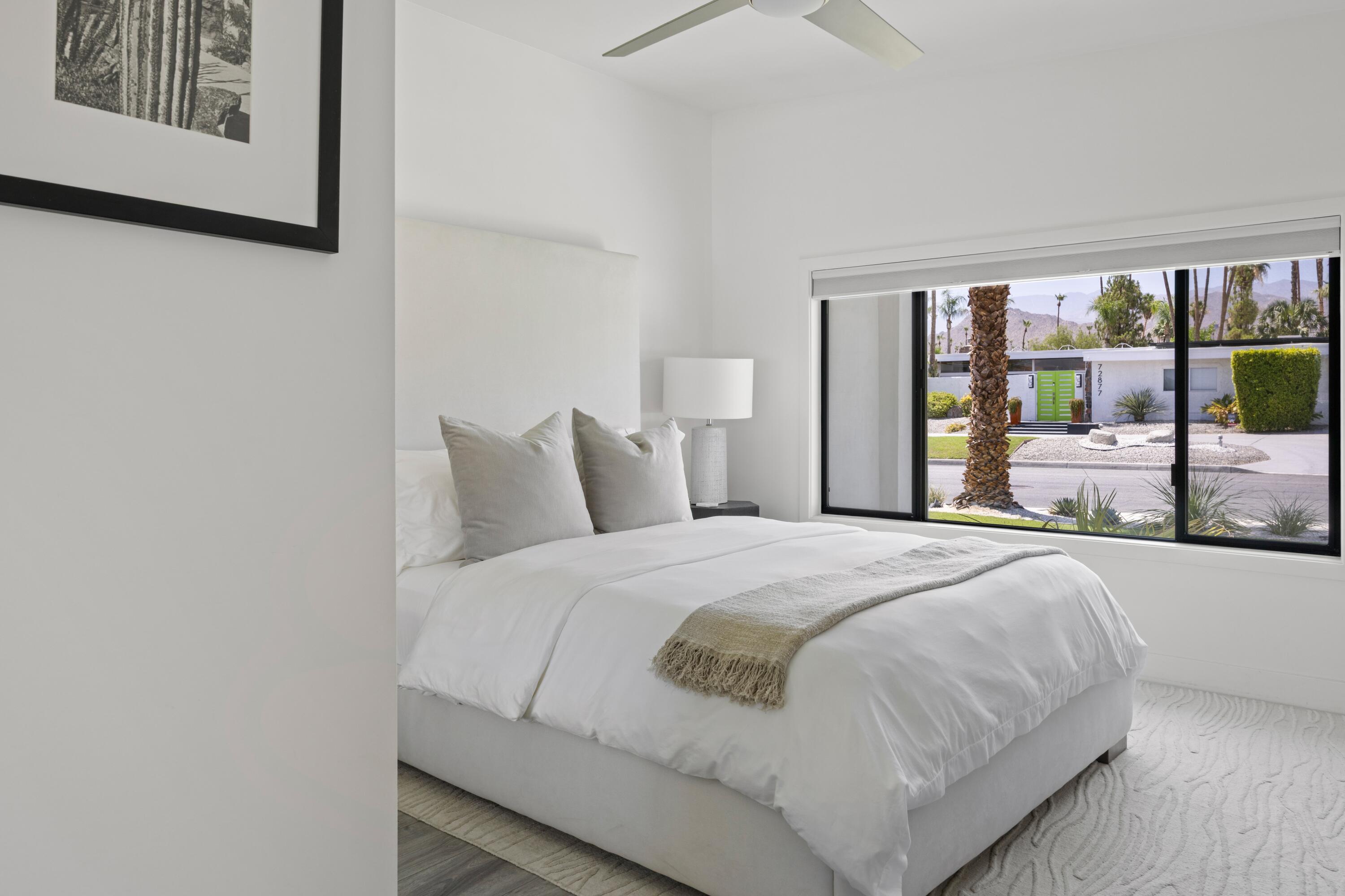 72870 Bel Air Road, Unit 3 Palm Desert, CA 92260 - Photo 12 of 35 a bedroom with a large bed and a large window