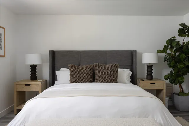 a bedroom with a bed and a lamp on table