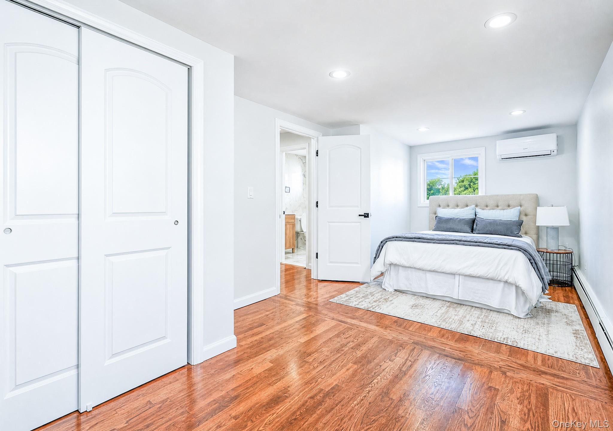 61 Cheshire Road Bethpage, NY 11714 - Photo 14 of 25 Hardwood flooring throughout featuring recessed lighting, a window with exterior views, and an individual climate control unit