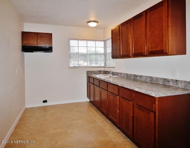 6328 Merrill Road Jacksonville, FL 32277 - Photo 5 of 10 a kitchen with a sink and cabinets