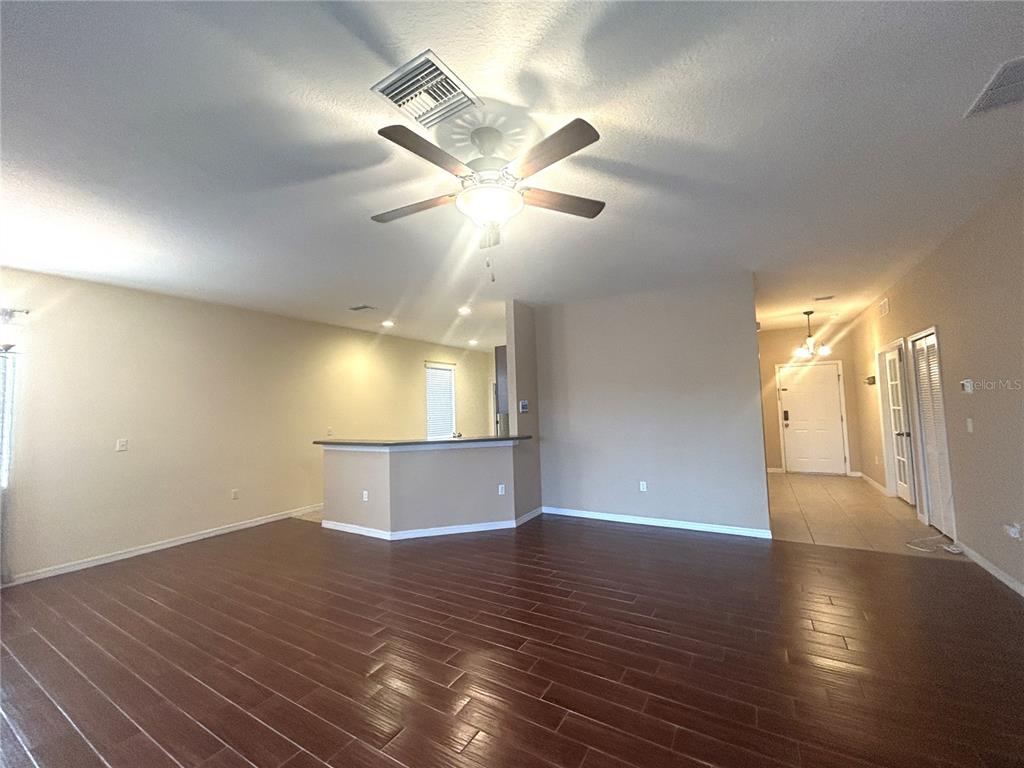 10702 Burning Bush Terrace Land O Lakes, FL 34638 - Photo 13 of 22 a view of an empty room with window and wooden floor