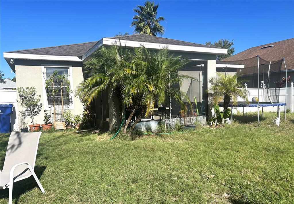 10702 Burning Bush Terrace Land O Lakes, FL 34638 - Photo 3 of 22 a backyard of a house with table and chairs