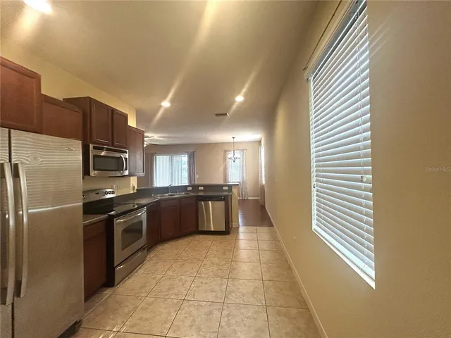 a large kitchen with stainless steel appliances lots of counter top space