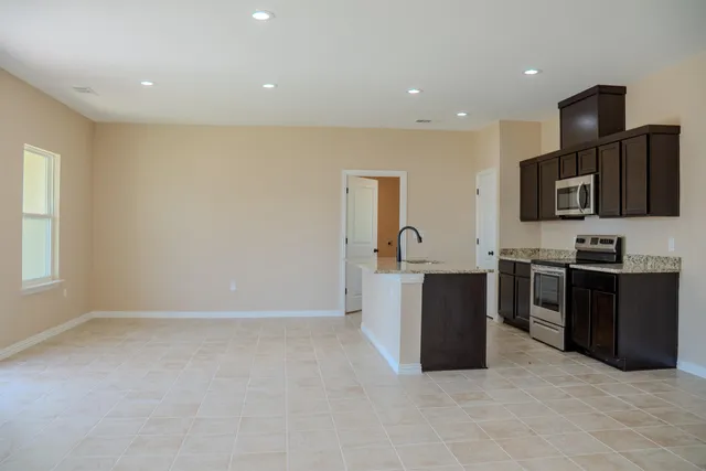 a kitchen with stainless steel appliances a refrigerator and a stove top oven