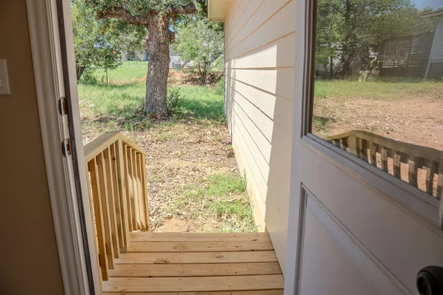 a view of a porch with wooden floor and outdoor space