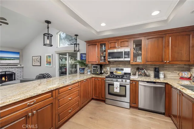 a kitchen with stainless steel appliances granite countertop a stove sink and cabinets