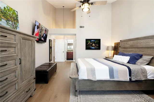 a bedroom with a bed and a chandelier